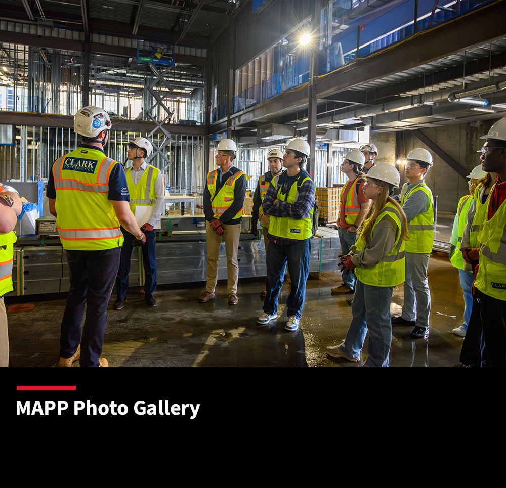 Students in yellow vests at a construction site