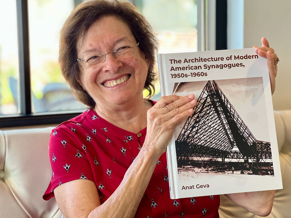 Anat Geva holding a book