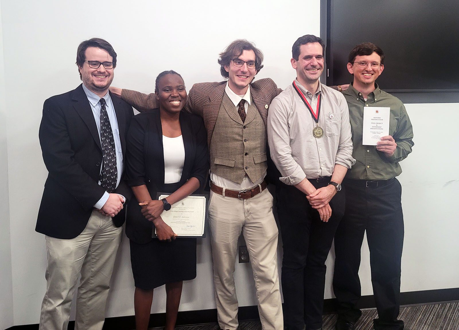 Students posing and holding awards