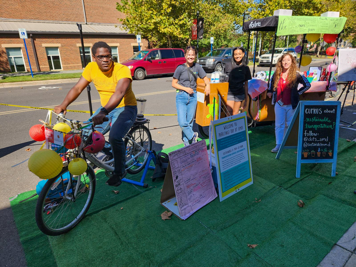 Guy on a bicycle by a booth