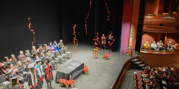 MAPP Commencement Fall 2019. Students on stage and streamers in the air.