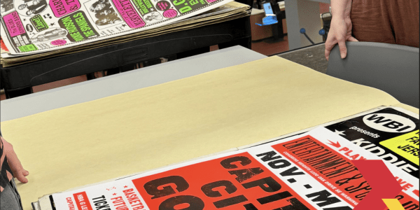 Colorful concert posters on a table