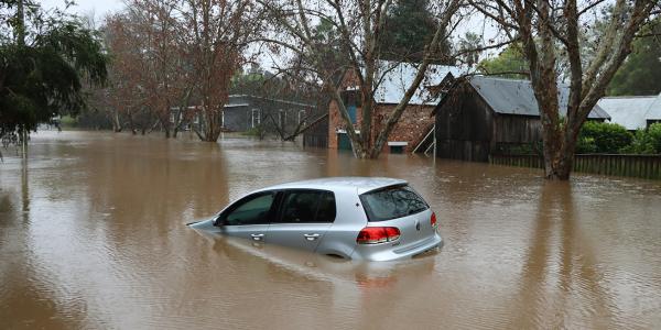 A car flooding in brown murky water