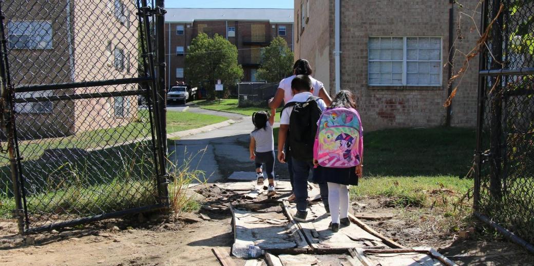 Back view of children with backpacks. 