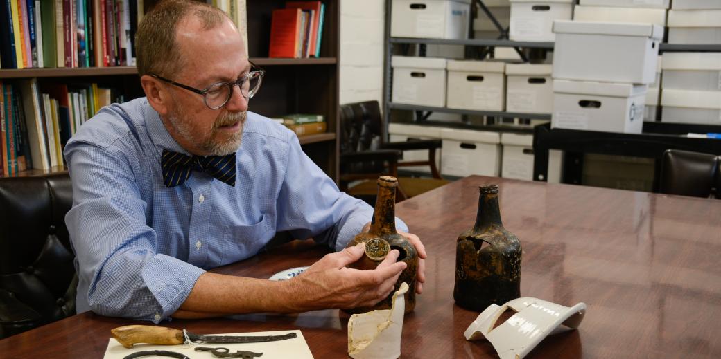 Interim Dean Donald Linebaugh working with artifacts from the Kippax Plantation Archaeological Site.