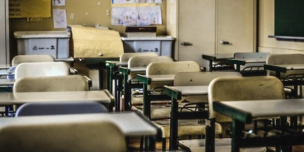 Rundown empty classroom chairs.