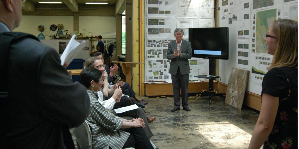 Carl Bovill clapping at a thesis presentation.