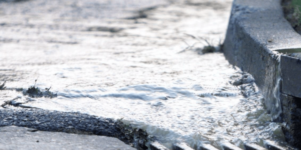 Stormwater running into a drain on the street