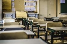 Rundown empty classroom chairs.