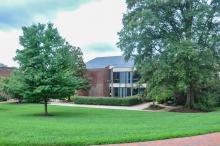 Outside Architecture building, green grass and patio area