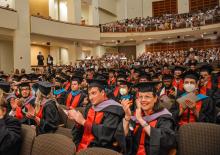 Spring 2022 Commencement, graduating students in audience clapping.