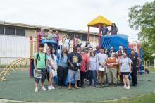 Children and PALS students and members in a playground