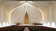 Interior of a synagogue with white curved walls