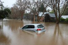 A car flooding in brown murky water