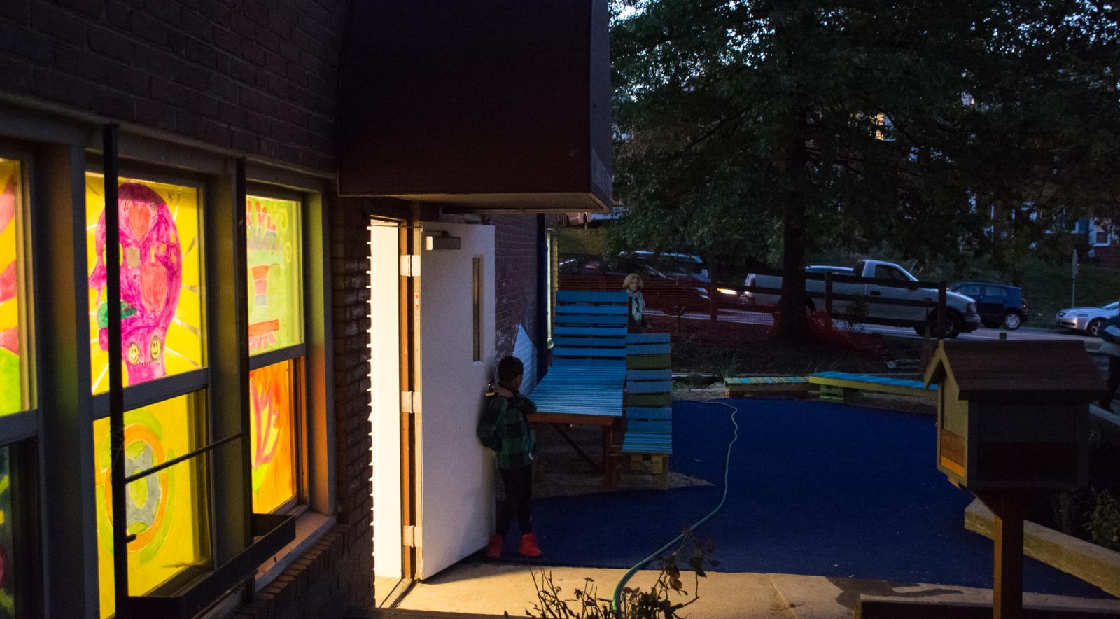 Night shot of the community center painted windows backlit.