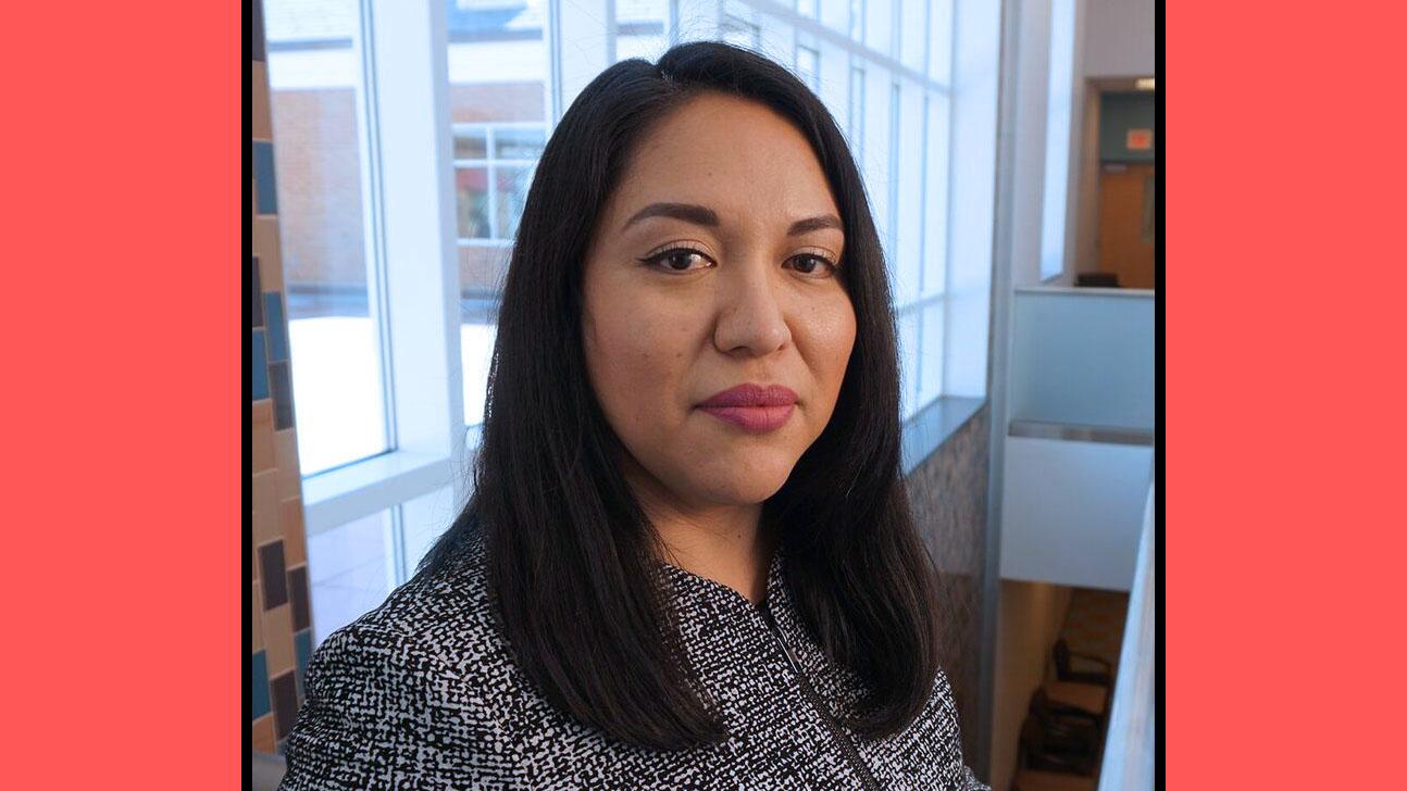 Dr. Perla Guerrero headshot with pink background