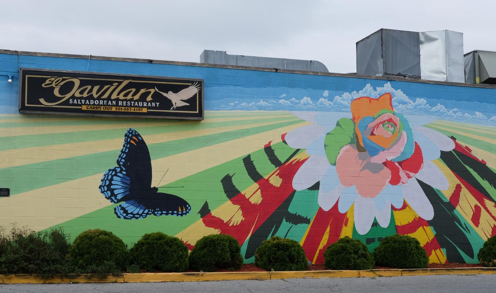 Flower and butterfly wall painting on the side of a building. Credit: A Long Life for Long Branch