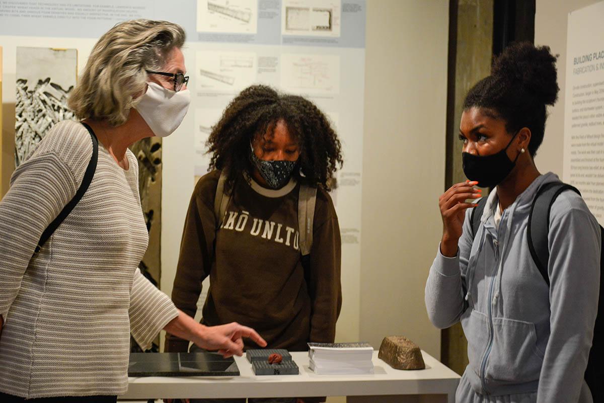 Larysa Kurylas and students talking in the Kibel Gallery, Holodomor exhibit