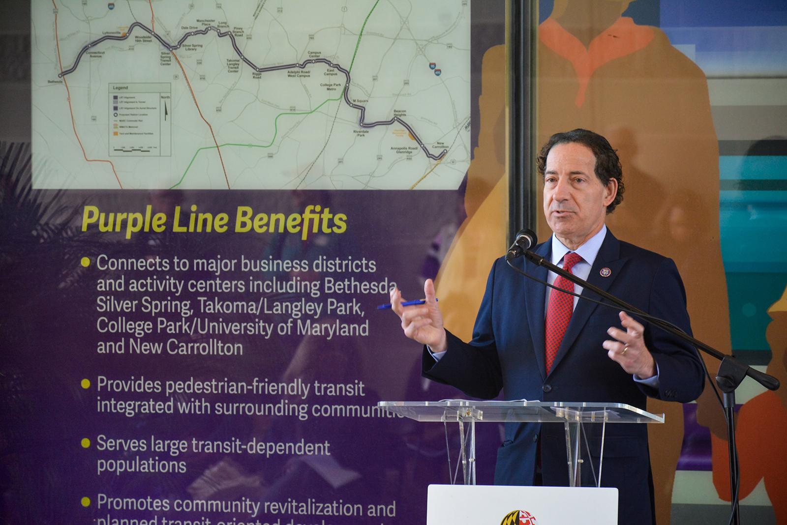 Jamie Raskin in front of Purple Line Corridor Coalition mural