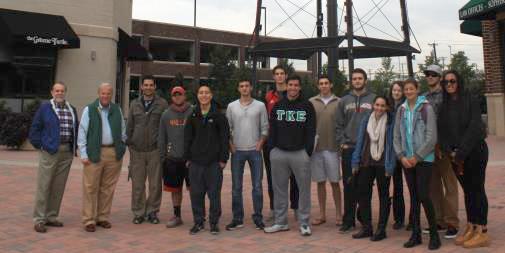 Group shot of people in front of a water tower