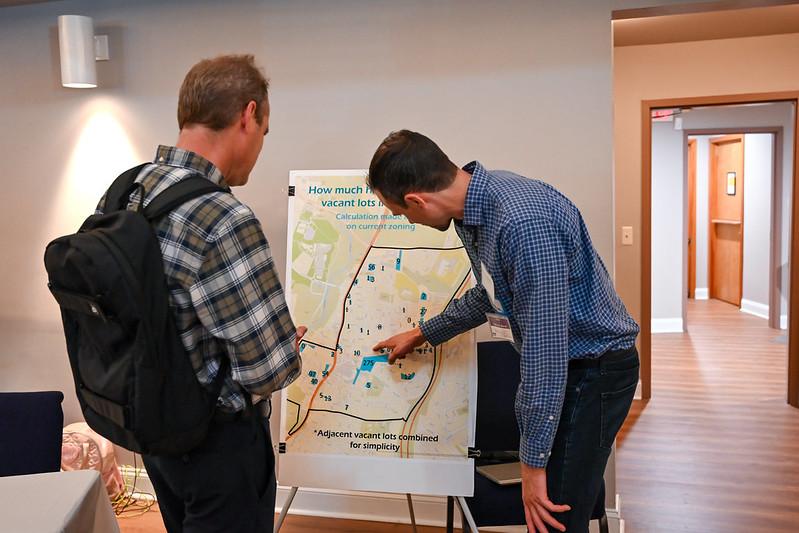 Student pointing at a poster board map