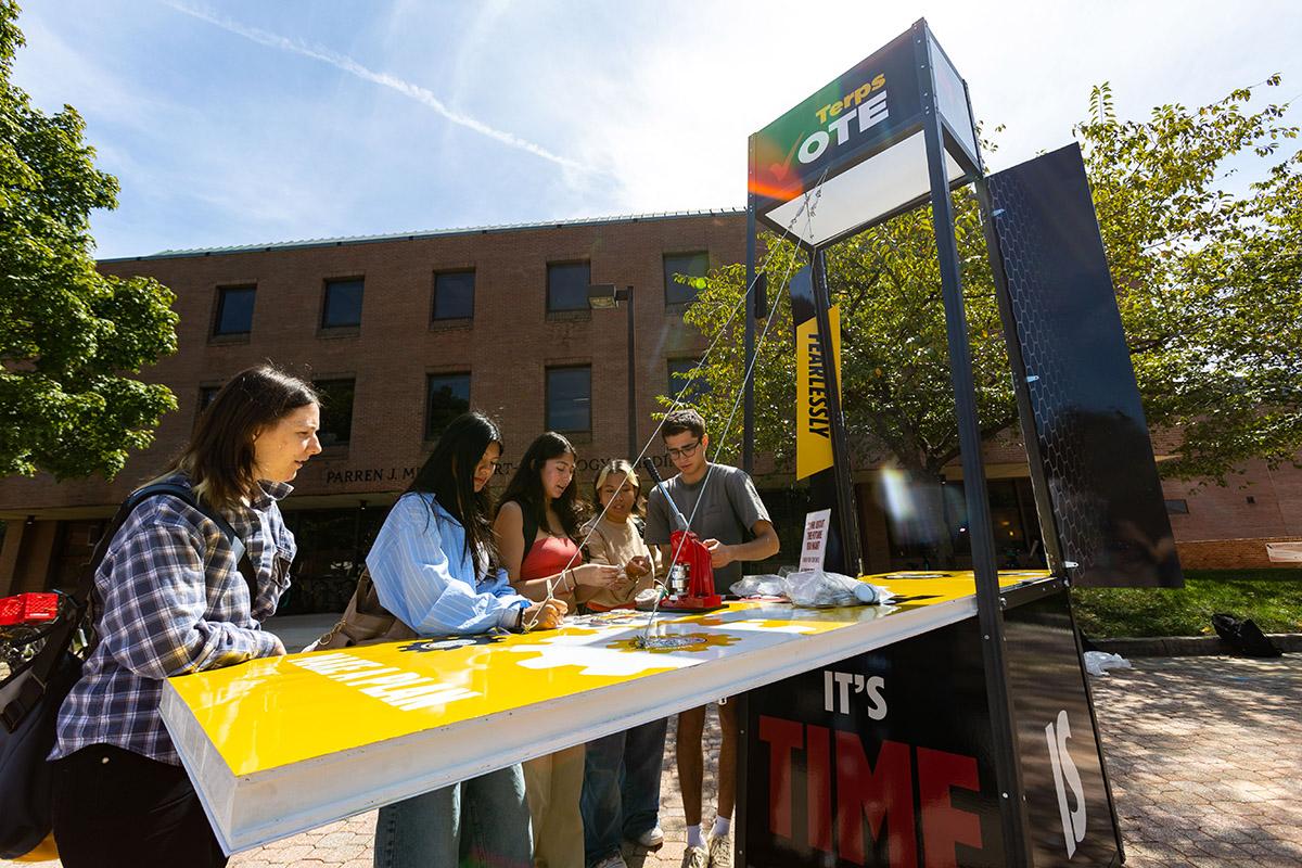 Students making buttons at the TerpsVote booth