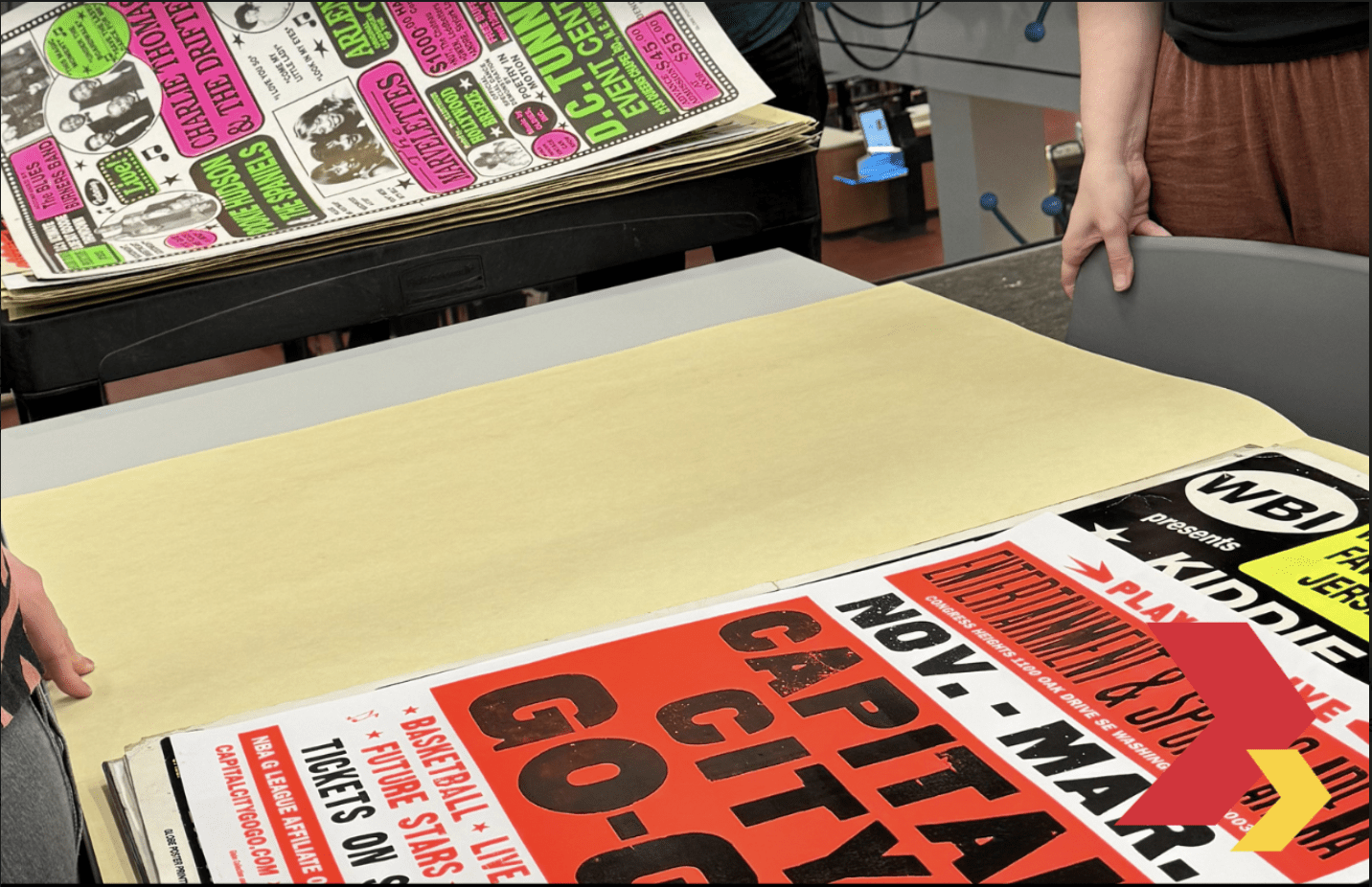 Colorful concert posters on a table