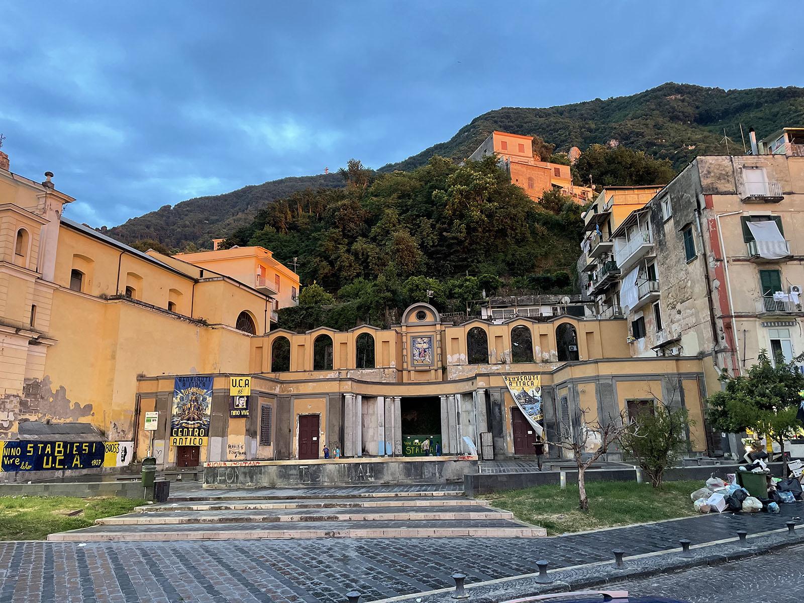 Historic buildings on a hill in Stabiae, Italy. Sunset colors are illuminating the facade.